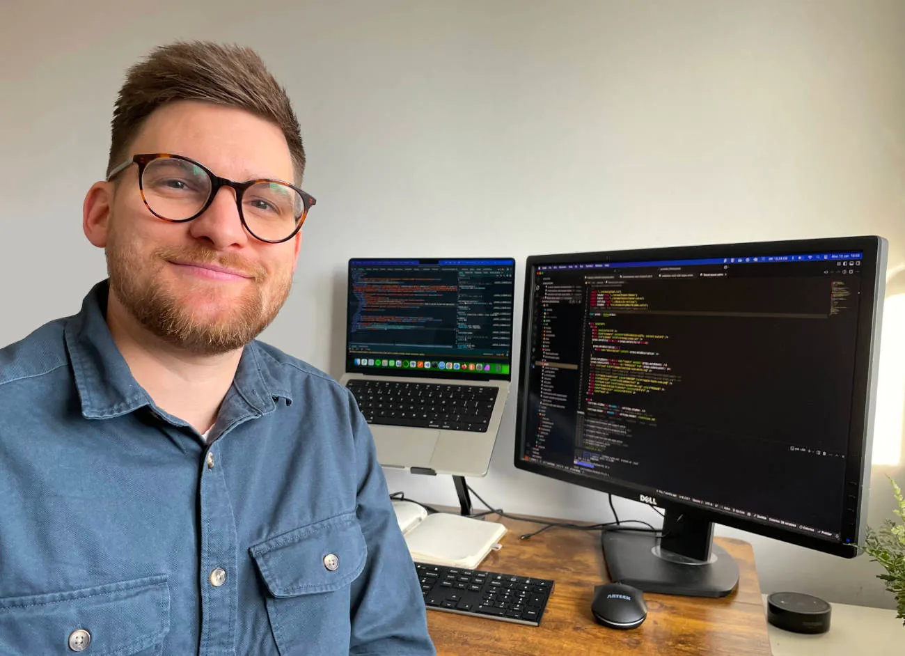 Photo of Joe Diton, founder of Joontide, smiling at his desk